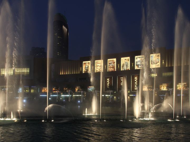 The Dubai Fountain at dusk with Downtown Dubai behind it